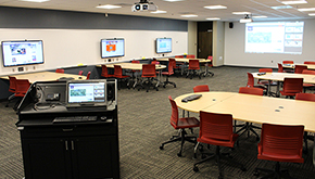 Classroom with group tables and television screens for each group table