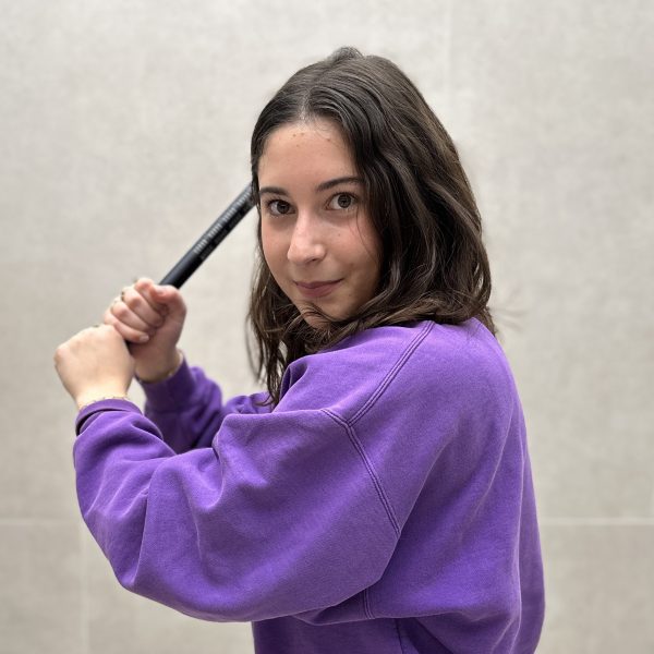 Naomi Birenbaum holding a shotgun microphone like a baseball bat