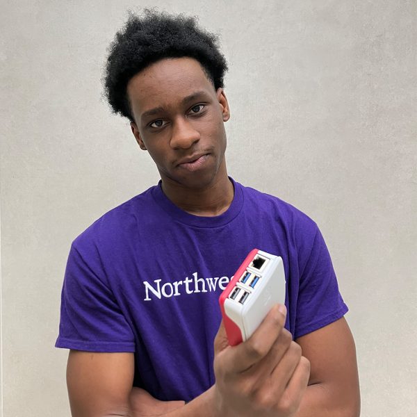 Photo of Lucas holding raspberry pi computer.